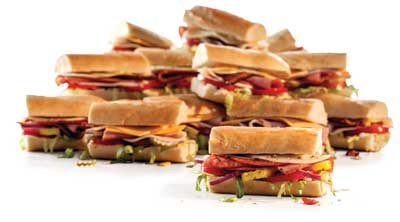 various party sized subs stacked up