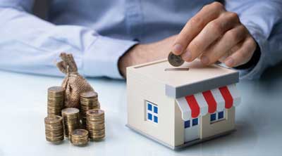 putting coin in a small business piggy bank